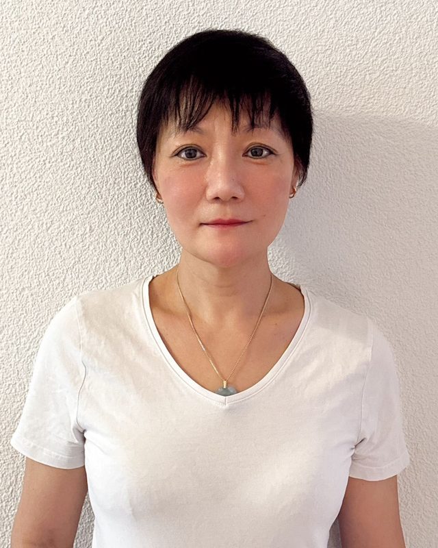 Porträt von Lin Jiang-Hutmacherin